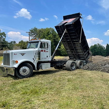 Pro Line Dump Truck unloading a bucket of dirt